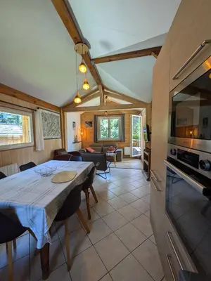 a kitchen and living room with a table in a room at Le Bivouac in Chamonix-Mont-Blanc