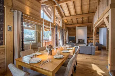 a dining room with a large wooden table and chairs at Chalet 1155 - Montroc - Chamonix in Chamonix-Mont-Blanc