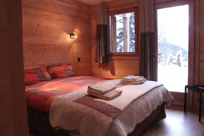 a bedroom with a bed with towels on it at Chalet 1155 - Montroc - Chamonix in Chamonix-Mont-Blanc