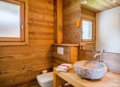 a bathroom with a stone sink in a wooden wall at Chalet 1155 - Montroc - Chamonix in Chamonix-Mont-Blanc