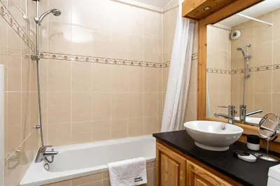 a bathroom with a tub and a sink and a shower at Le Paradis 28 Apartment- Chamonix All Year in Chamonix-Mont-Blanc