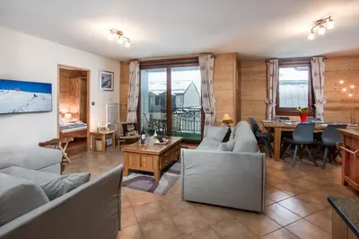 a living room with a couch and a table at Le Paradis 28 Apartment- Chamonix All Year in Chamonix-Mont-Blanc