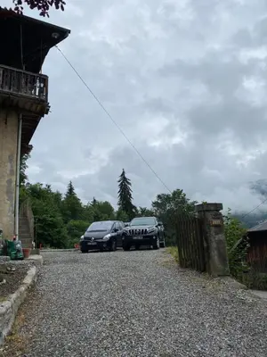 two cars parked in a driveway next to a house at Chalet Le Triollet in Saint-Gervais-les-Bains