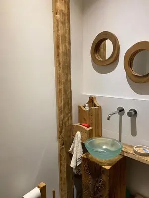 a bathroom with a wooden sink and two wooden circles on the wall at Chalet Le Triollet in Saint-Gervais-les-Bains