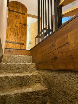 a set of stairs leading up to a wooden door at Chalet Le Triollet in Saint-Gervais-les-Bains