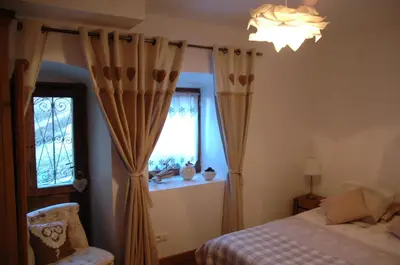 a bedroom with a bed and a window at Chalet Le Triollet in Saint-Gervais-les-Bains
