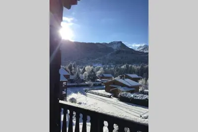 a view from a balcony of a snow covered mountain at Eden Roc Grand Massif in Les Carroz d'Araches