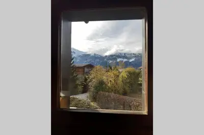 a window in a room with a view of mountains at Eden Roc Grand Massif in Les Carroz d'Araches