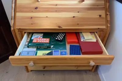 a wooden drawer filled with lots of books at Eden Roc Grand Massif in Les Carroz d'Araches