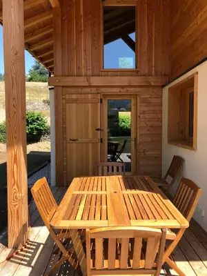 a wooden table and chairs on the porch of a cabin at Prestigious Chalet in Saint-Gervais-les-Bains