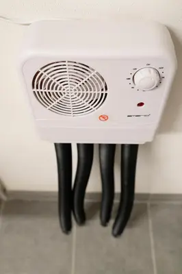 a white fan with black legs in a kitchen at Prestigious Chalet in Saint-Gervais-les-Bains