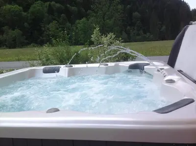 a hot tub with water coming out of it at L'Erine des Alpes SPA Chalet individuel grand confort in Sixt