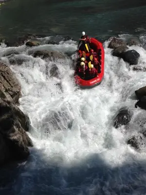 a group of people in a red boat in a river at L'Erine des Alpes SPA Chalet individuel grand confort in Sixt