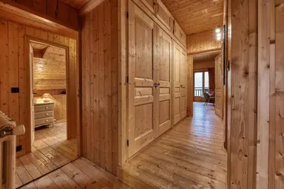 a hallway in a log cabin with wooden walls at La ferme des ours in Saint-Gervais-les-Bains