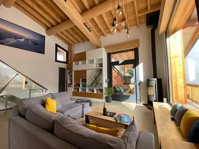 a living room with a couch and a table at Chalet Mountain Vibes in Les Houches