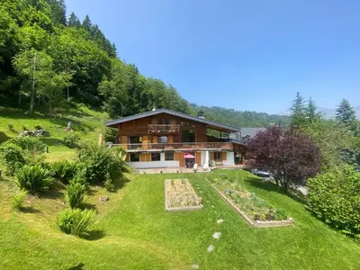a house on a hill with a garden at Chalet Mountain Vibes in Les Houches