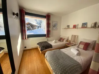 a bedroom with two beds and a window at Chalet Mountain Vibes in Les Houches