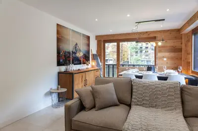 a living room with a couch and a table at Apartment Brevent Fodera in Chamonix-Mont-Blanc