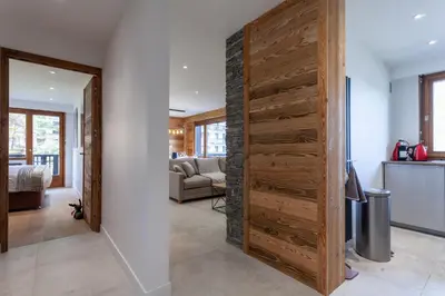 a large wooden door in a living room at Apartment Brevent Fodera in Chamonix-Mont-Blanc