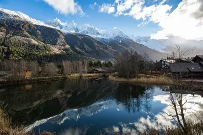 a view of a lake with mountains in the background at Résidence Luxe 5*,Spa & Fitness, La Cordée Appartement 821 in Chamonix-Mont-Blanc