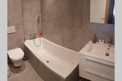 a bathroom with a tub and a toilet and a sink at Résidence Luxe 5*,Spa & Fitness, La Cordée Appartement 821 in Chamonix-Mont-Blanc