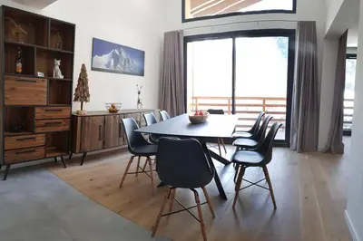a dining room with a table and chairs at Résidence Luxe 5*,Spa & Fitness, La Cordée Appartement 821 in Chamonix-Mont-Blanc