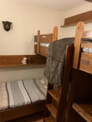 two wooden bunk beds in a room with at La clé des montagnes in Les Houches