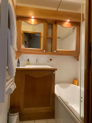 a bathroom with a tub and a sink and a bath tub at La clé des montagnes in Les Houches