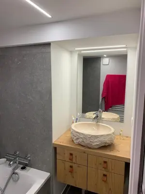 a bathroom with a sink and a large mirror at Flaine Forum L1 Cassiopée Mezzanine & Terrasse in Flaine