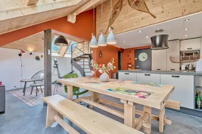 a kitchen and dining room with a wooden table and benches at Vues incroyables - Glaciers, lacs et montagnes in Chamonix-Mont-Blanc