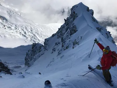 a person on skis standing on a snow covered mountain at Vues incroyables - Glaciers, lacs et montagnes in Chamonix-Mont-Blanc