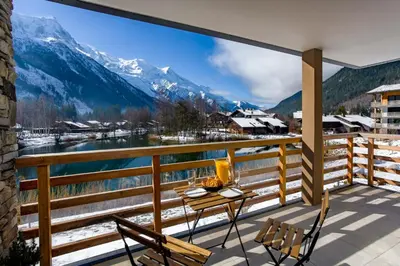a balcony with a table and chairs and a view of a mountain at La Cordee 612 apartment- Chamonix All Year in Chamonix-Mont-Blanc