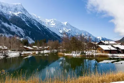 a lake in front of a snow covered mountain at La Cordee 612 apartment- Chamonix All Year in Chamonix-Mont-Blanc