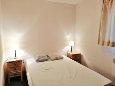 a bedroom with a bed and two night stands with lamps at Charmant Duplex 3 Chambres à 100m des Pistes, Parking, WIFI - FR-1-815-73 in Morillon