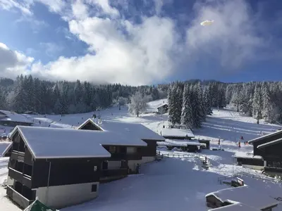 a snow covered ski slope with buildings and trees at Charmant Duplex 3 Chambres à 100m des Pistes, Parking, WIFI - FR-1-815-73 in Morillon
