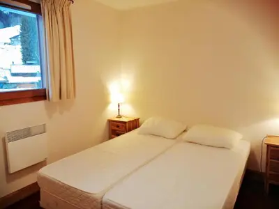 a bedroom with a white bed and a window at Charmant Duplex 3 Chambres à 100m des Pistes, Parking, WIFI - FR-1-815-73 in Morillon