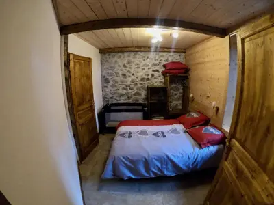a small bedroom with a bed in a room at LA FERME DU FAY in Sixt