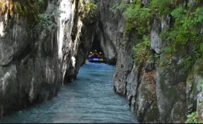 a river in a cave with a boat in it at LA FERME DU FAY in Sixt