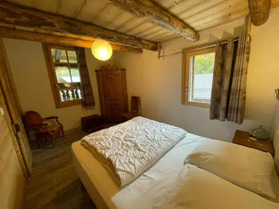a bedroom with a bed and a window at LA FERME DU FAY in Sixt