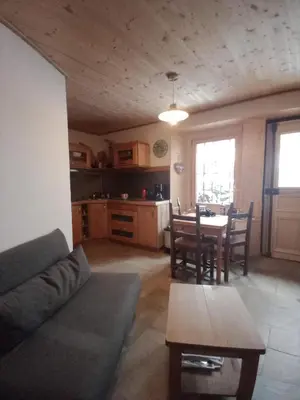 a living room with a couch and a table at LA FERME DU FAY in Sixt