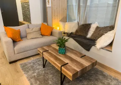 a living room with a couch and a coffee table at Apartment Chinook,La Praz,Chamonix Mont Blanc in Chamonix-Mont-Blanc