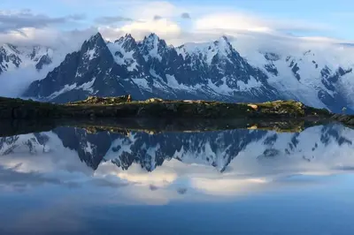 a mountain range with its reflection in a body of water at Apartment Chinook,La Praz,Chamonix Mont Blanc in Chamonix-Mont-Blanc