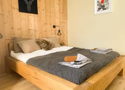 a bedroom with a bed with a wooden frame at Apartment Chinook,La Praz,Chamonix Mont Blanc in Chamonix-Mont-Blanc