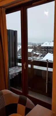 a room with a window with a view of a city at Le Duplex Septimontain in Samoëns