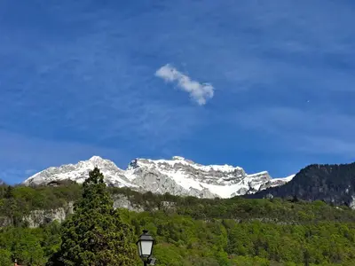a snow covered mountain in the distance with a street light at Le Duplex Septimontain in Samoëns