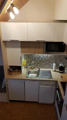 a small kitchen with a sink and a stove at Le Duplex Septimontain in Samoëns