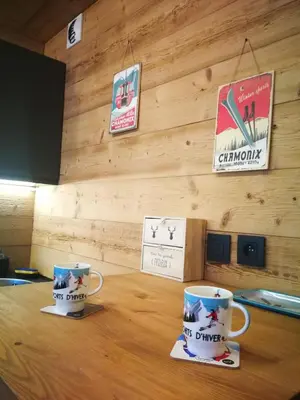 two coffee cups sitting on top of a wooden table at Le Gypaète in Chamonix-Mont-Blanc