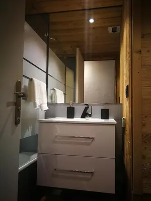 a bathroom with a white sink and a mirror at Le Gypaète in Chamonix-Mont-Blanc