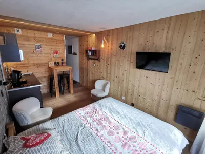 a bedroom with a bed and a wooden wall at Le Gypaète in Chamonix-Mont-Blanc