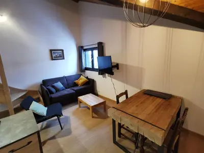 a living room with a couch and a table at Le Mallory in Chamonix-Mont-Blanc